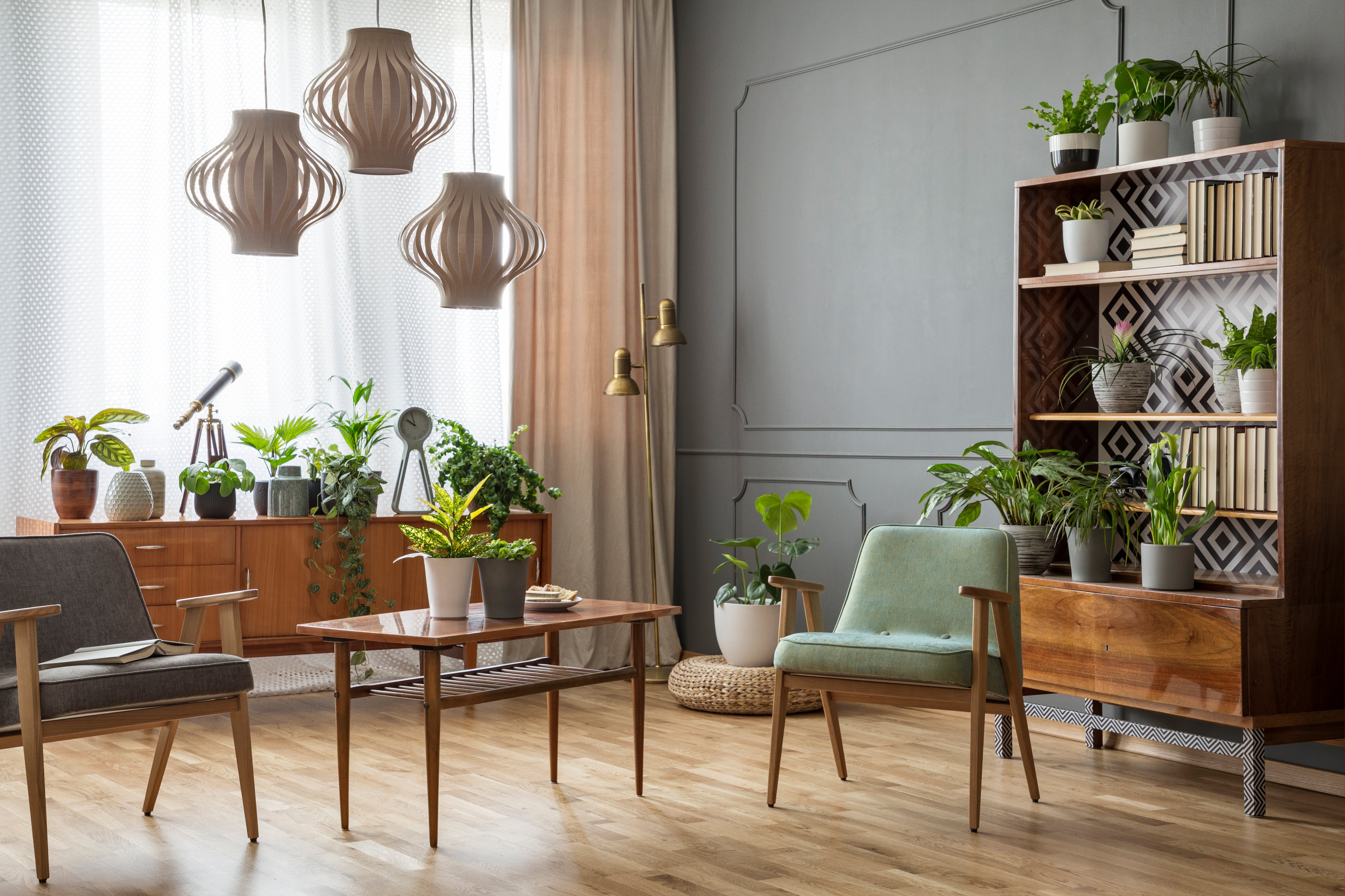 wooden-table-with-flowers-between-armchairs-in-gre-2023-11-27-05-12-04-utc.jpg